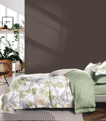 Egyptian bed in a bag set with sage green botanical floral print duvet cover, matching pillowcases and reversible solid sage green bedding in a modern boho bedroom